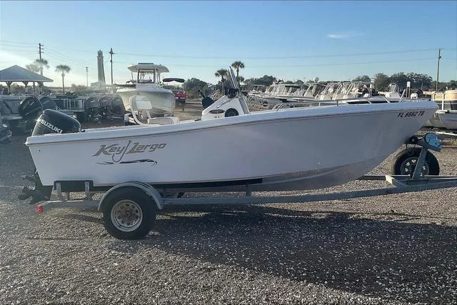Slide: The Image of 2021 Key Largo 1800 CC boat on trailer in a marina setting. - 7