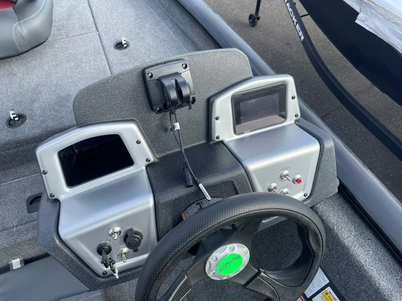 Slide: The Image of 2025 Tracker Pro Team 175 TXW® boat dashboard with steering wheel and control panels. - 10