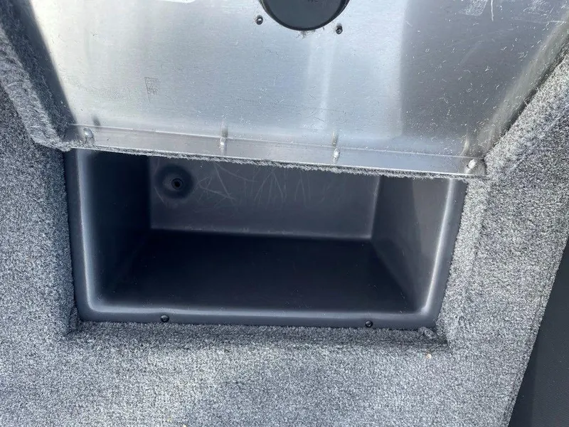 Slide: The Image of Storage compartment of 2025 Tracker Pro Team 175 TXW® boat, carpeted interior. - 15