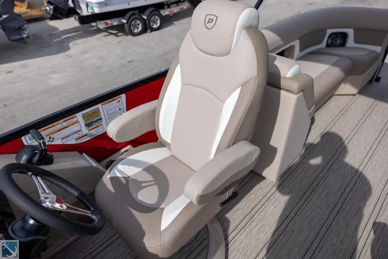 Slide: The Image of Premier 250 Solaris RF 2025 boat interior with beige captain's chair and steering wheel. - 10