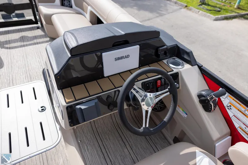 Slide: The Image of 2025 Premier 250 Solaris RF boat dashboard with steering wheel and Simrad display. - 11