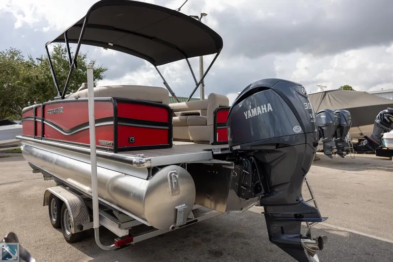 Slide: The Image of 2025 Premier 250 Solaris RF pontoon boat with Yamaha engine on trailer. - 3
