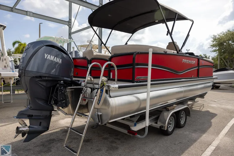 Slide: The Image of 2025 Premier 250 Solaris RF pontoon boat with Yamaha motor on trailer. - 5