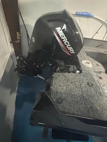 Slide: The Image of 2025 Tracker PG V16 SC boat with Mercury outboard motor in garage. - 10