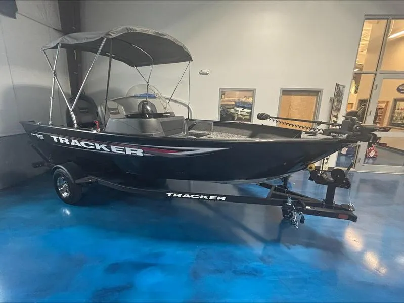 Slide: The Image of 2025 Tracker PG V16 SC boat displayed indoors on a blue floor. - 3