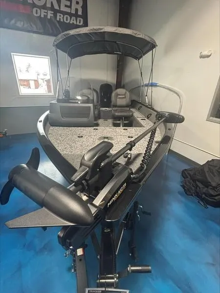 Slide: The Image of 2025 Tracker PG V16 SC fishing boat with canopy and trolling motor in showroom. - 5