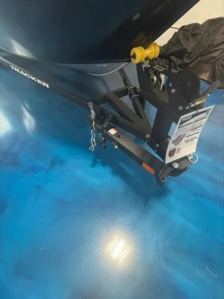 Slide: The Image of 2025 Tracker PG V16 SC boat trailer on blue floor. - 8