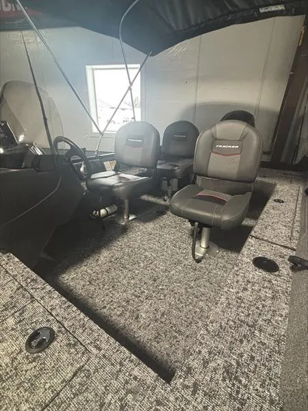 Slide: The Image of 2025 Tracker PG V16 SC boat interior with gray seating and carpeted flooring. - 9