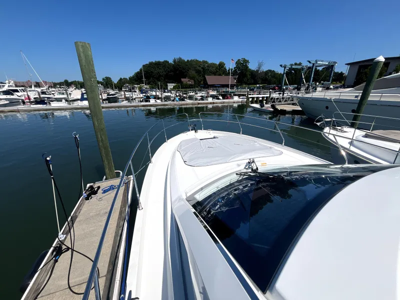 Slide: The Image of 2023 Beneteau Gran Turismo 41 docked at a marina under clear blue skies. - 12