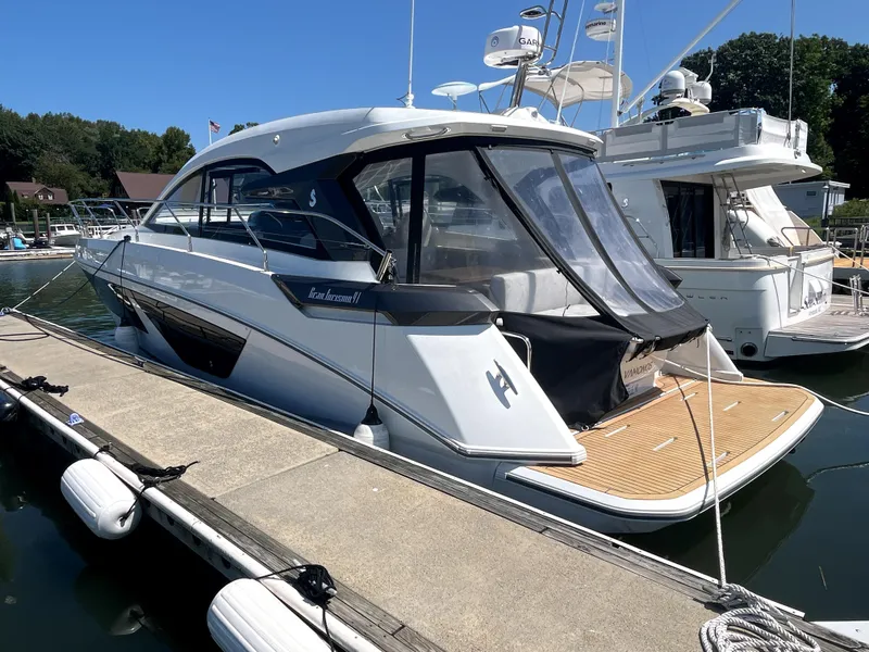 Slide: The Image of 2023 Beneteau Gran Turismo 41 yacht docked at marina, rear view. - 19