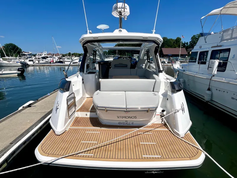 Slide: The Image of 2023 Beneteau Gran Turismo 41 yacht docked at marina, rear view. - 20