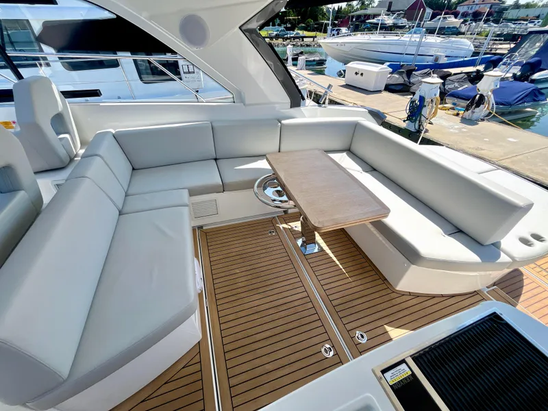 Slide: The Image of Luxurious seating area on 2023 Beneteau Gran Turismo 41 yacht, featuring sleek design and wooden flooring. - 21