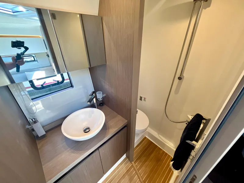 Slide: The Image of Modern bathroom in 2023 Beneteau Gran Turismo 41 yacht with sleek fixtures and wood accents. - 29