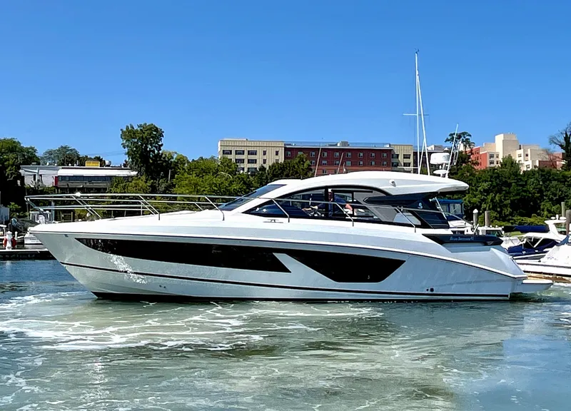 Slide: The Image of 2023 Beneteau Gran Turismo 41 yacht on water, urban backdrop, clear sky. - 6