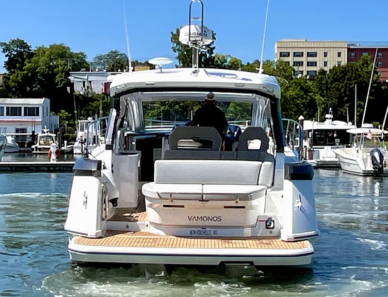 Slide: The Image of 2023 Beneteau Gran Turismo 41 yacht docked in a marina, rear view. - 9