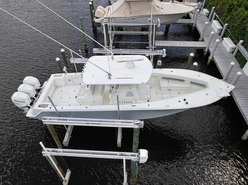 Slide: The Image of 2017 SeaVee 370z boat docked with triple outboard engines. - 16