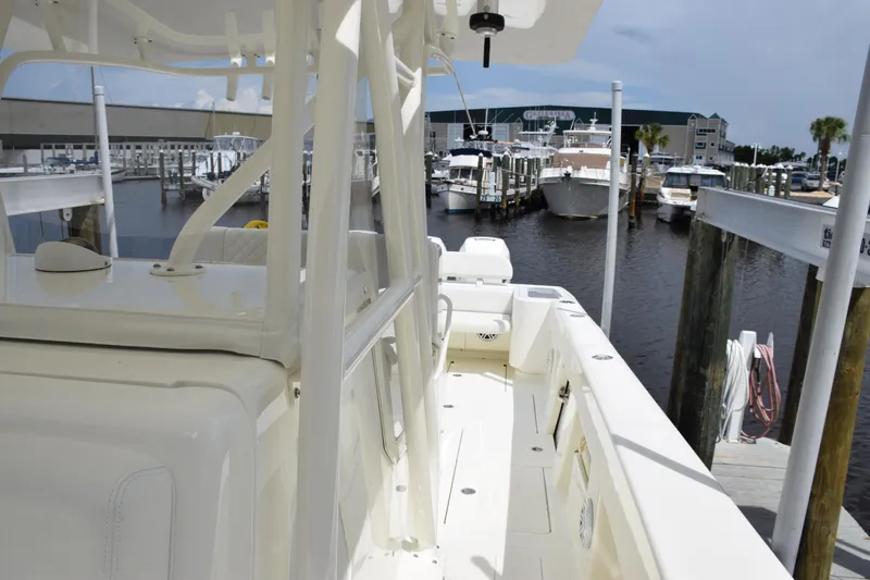 Slide: The Image of 2017 SeaVee 370z boat docked at a marina, showcasing sleek design and spacious deck. - 22