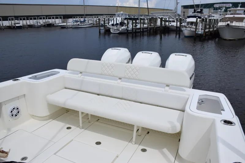 Slide: The Image of 2017 SeaVee 370z boat with triple engines, docked at a marina. - 28