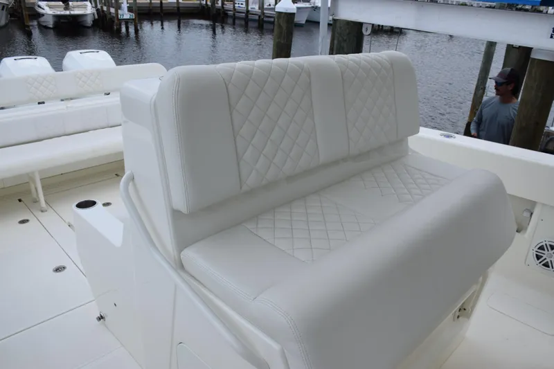 Slide: The Image of 2017 SeaVee 370z boat with white quilted seating by the dock. - 34
