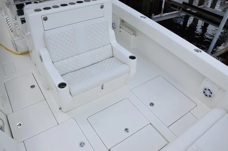 Slide: The Image of 2017 SeaVee 370z boat interior with white seating and storage compartments. - 36