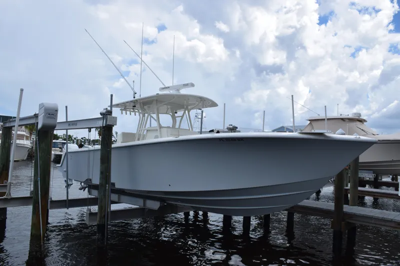 Slide: The Image of 2017 SeaVee 370z boat docked on lift under cloudy sky. - 9