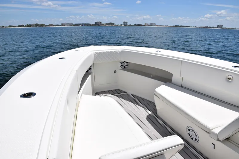 Slide: The Image of 2017 SeaVee 390Z boat interior with seating, on calm ocean waters. - 10