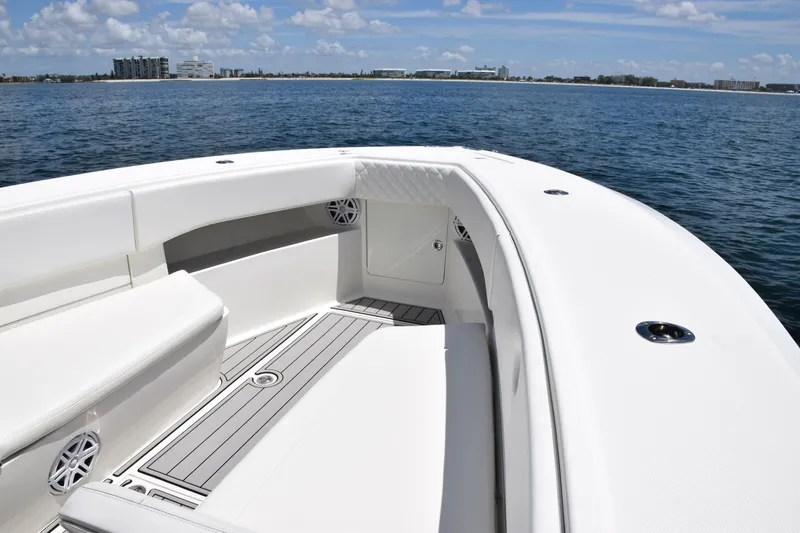 Slide: The Image of 2017 SeaVee 390Z boat deck with seating, on calm ocean waters. - 11