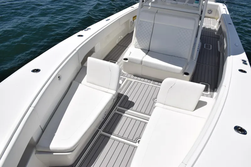 Slide: The Image of 2017 SeaVee 390Z boat interior with white seating and spacious deck. - 18