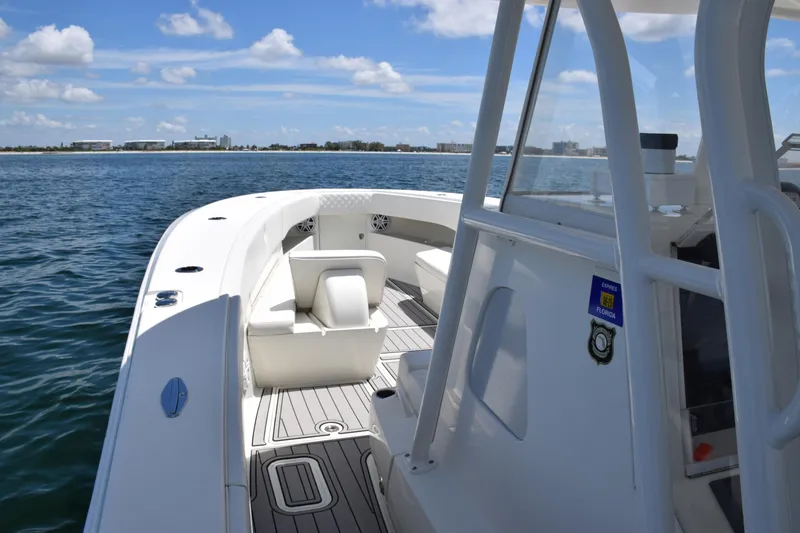 Slide: The Image of 2017 SeaVee 390Z boat on calm water, showcasing sleek deck design and seating. - 19