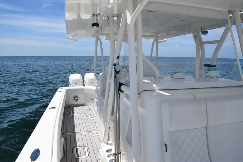 Slide: The Image of 2017 SeaVee 390Z boat on open water, featuring sleek white design and spacious deck. - 22