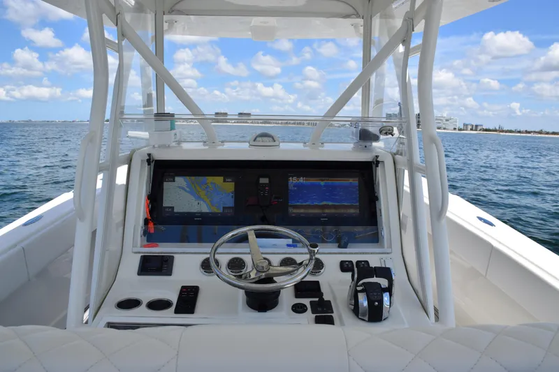 Slide: The Image of 2017 SeaVee 390Z boat dashboard with navigation screens on open water. - 27