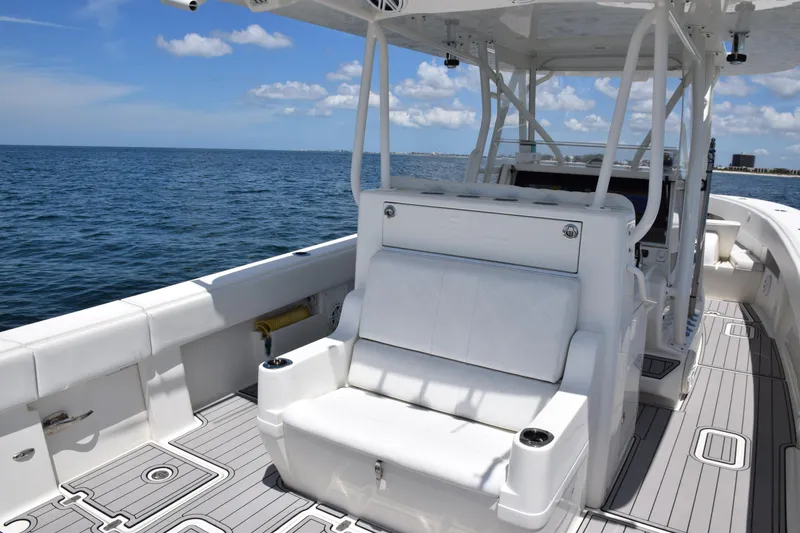 Slide: The Image of 2017 SeaVee 390Z boat interior with white seating, ocean view, and clear sky. - 31