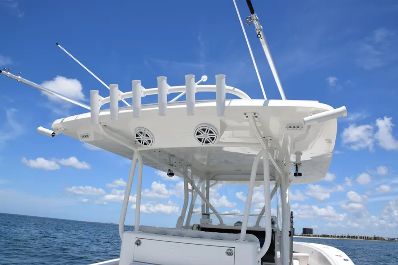 Slide: The Image of 2017 SeaVee 390Z boat with rod holders and speakers, under a clear blue sky. - 32