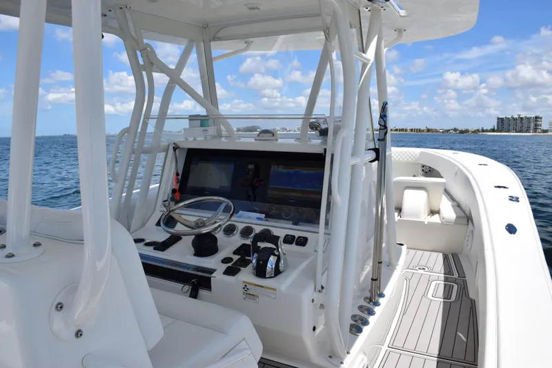 Slide: The Image of 2017 SeaVee 390Z boat cockpit with steering wheel, navigation screens, and ocean view. - 39