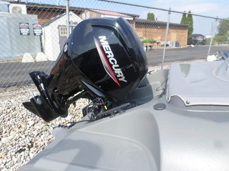 Slide: The Image of 2024 Bankes Crusader 19 with Mercury outboard motor, parked on gravel. - 4