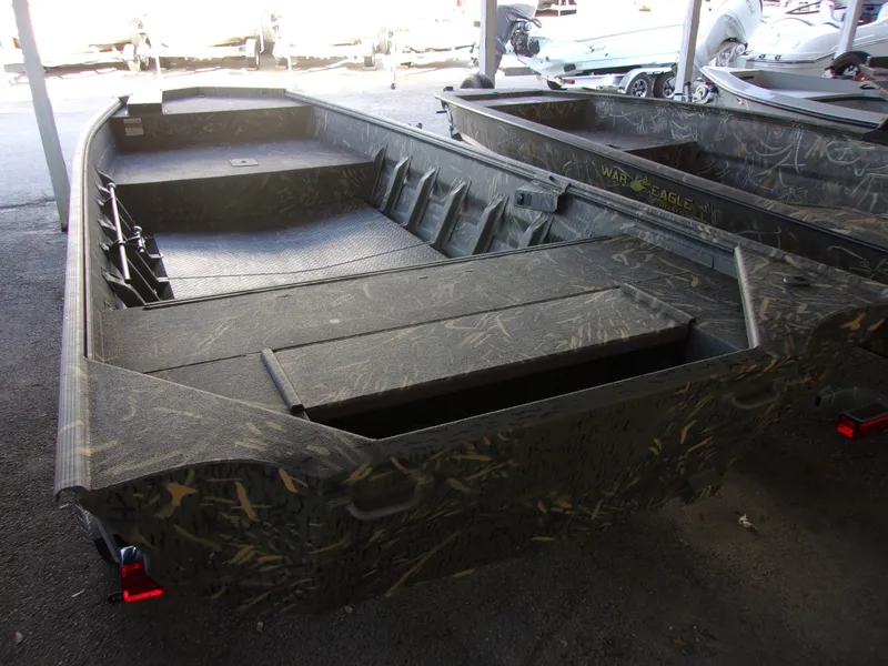 Slide: The Image of 2025 War Eagle 754 LDV boat with camouflage design in a showroom. - 6