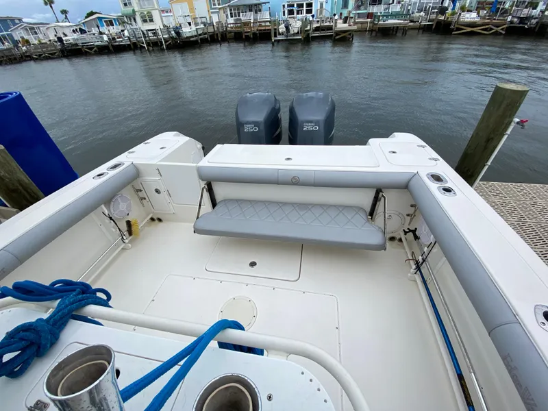 Slide: The Image of 2007 Edgewater 318CC boat with twin engines docked by waterfront homes. - 10