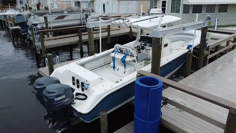 Slide: The Image of 2007 Edgewater 318CC boat docked with twin Yamaha engines. - 12