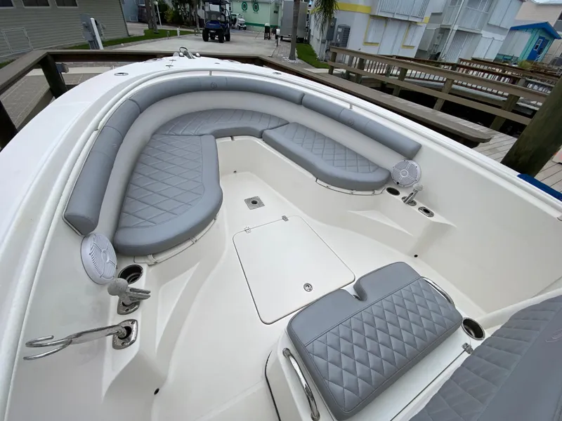 Slide: The Image of 2007 Edgewater 318CC boat with gray cushioned seating and spacious deck. - 14