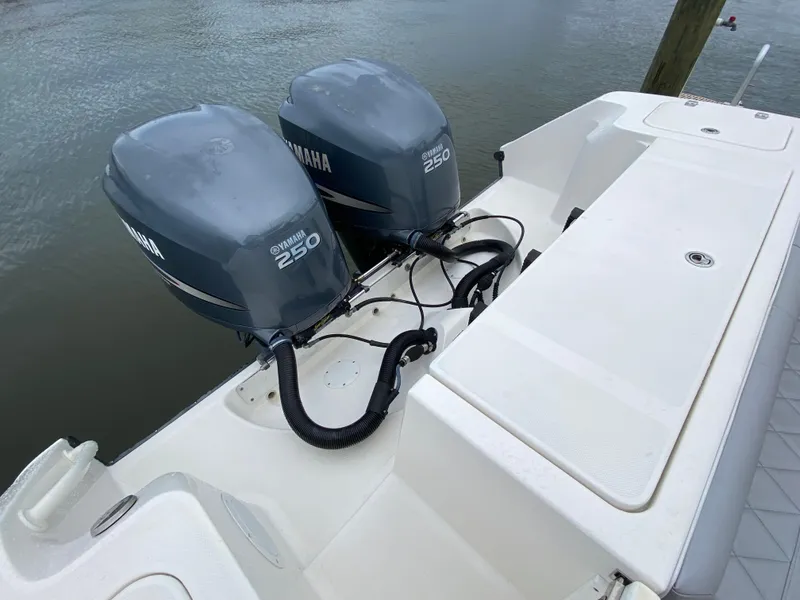 Slide: The Image of 2007 Edgewater 318CC boat with twin Yamaha 250 engines on a calm water backdrop. - 15
