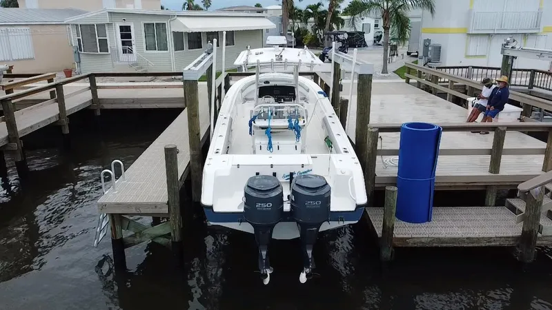 Slide: The Image of Edgewater 318CC 2007 boat docked at marina with twin engines. - 16