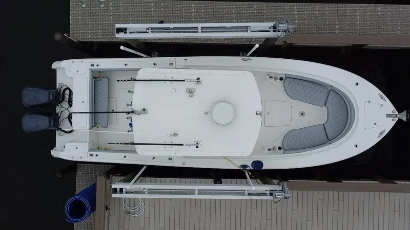 Slide: The Image of Aerial view of 2007 Edgewater 318CC boat docked, featuring dual engines and spacious deck. - 18