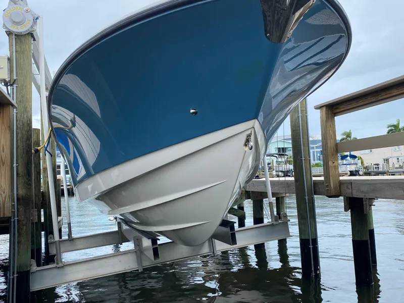 Slide: The Image of 2007 Edgewater 318CC boat on lift, dockside view. - 19