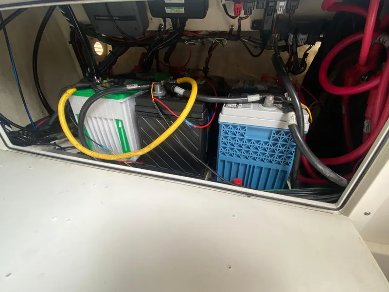 Slide: The Image of 2007 Edgewater 318CC boat battery compartment with wiring and connections. - 22
