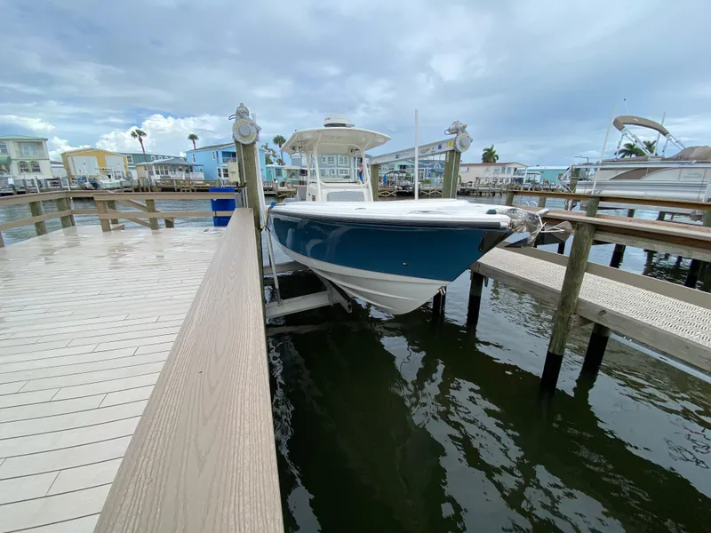 Slide: The Image of 2007 Edgewater 318CC boat docked at a marina under cloudy skies. - 7
