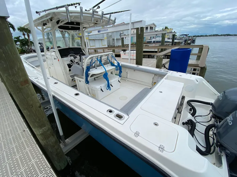 Slide: The Image of 2007 Edgewater 318CC boat docked by waterfront homes. - 9