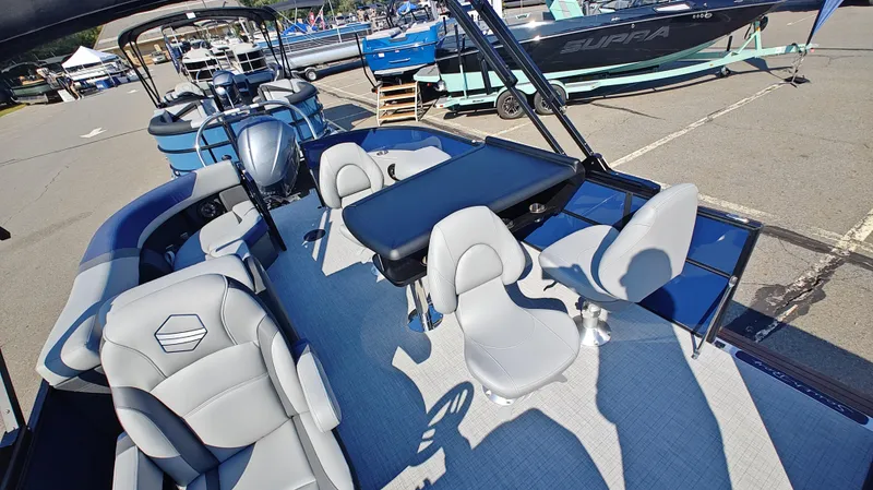 Slide: The Image of 2025 South Bay 224E 3.0 pontoon boat interior with modern seating and table. - 4