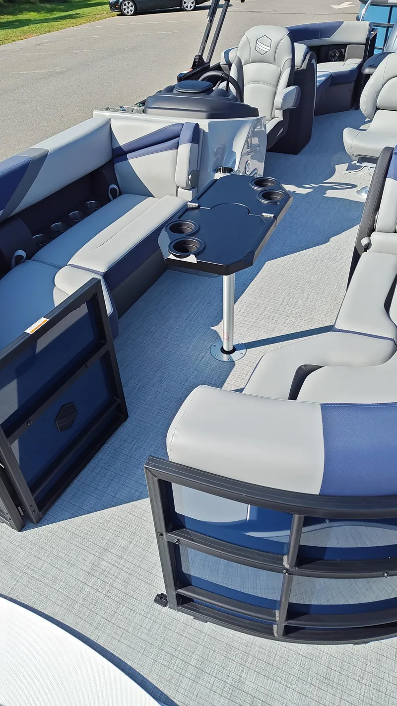 Slide: The Image of 2025 South Bay 224E 3.0 pontoon boat interior with plush seating and table. - 6