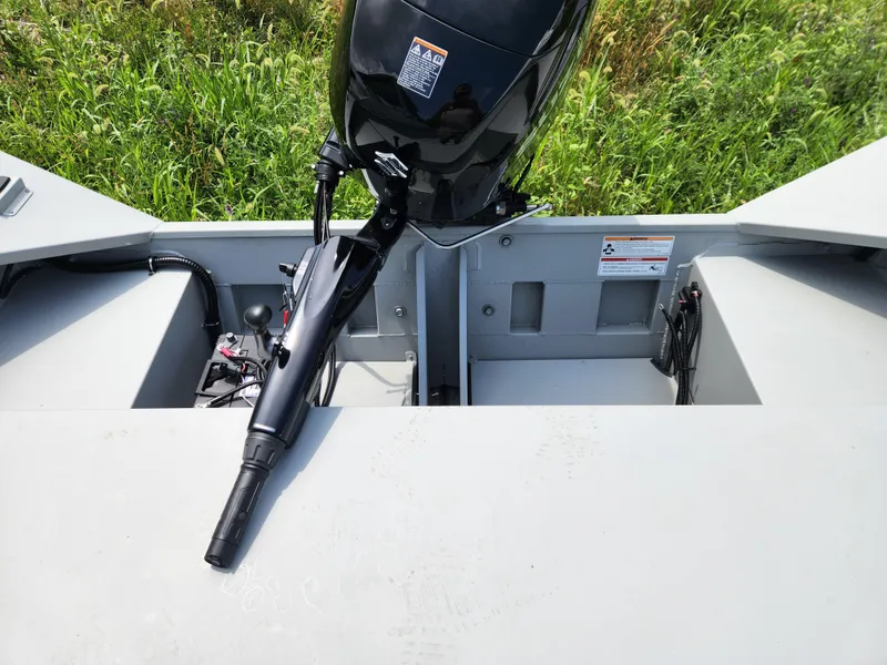 Slide: The Image of 2024 SeaArk 2072 MV boat with outboard motor, viewed from above, in grassy area. - 8