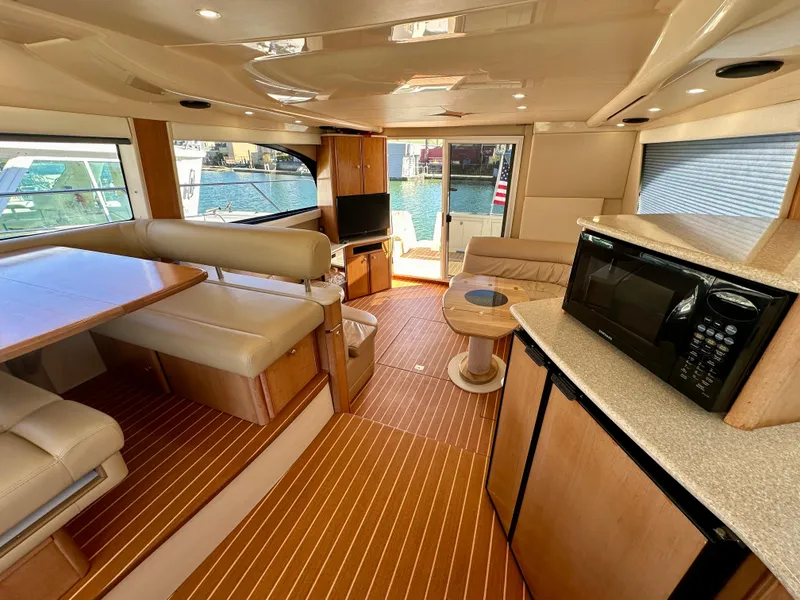 Slide: The Image of Interior of 2003 Meridian 411 Sedan yacht with dining area and kitchenette. - 13